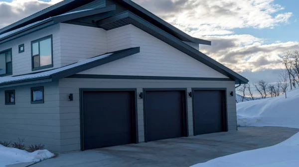 Panorama crop Garage entrance of a home on the scenic snowy terrain of Wasatch Mountains