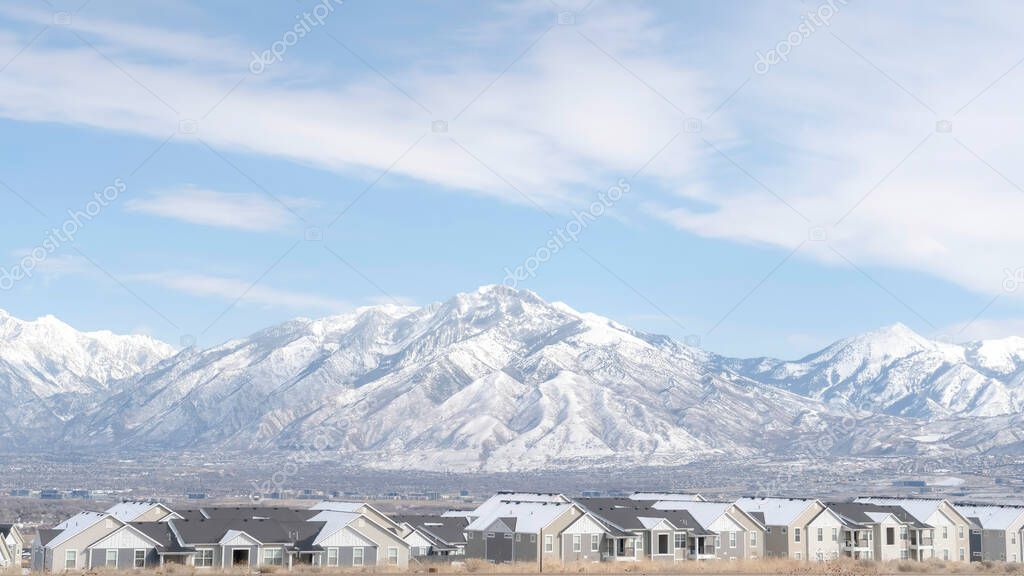 Panorama frame Striking Wasatch Mountains and South Jordan City in Utah during winter season