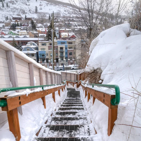 Square Outdoor stairs overlooking snowy Park City neighborhood and mountain in winter