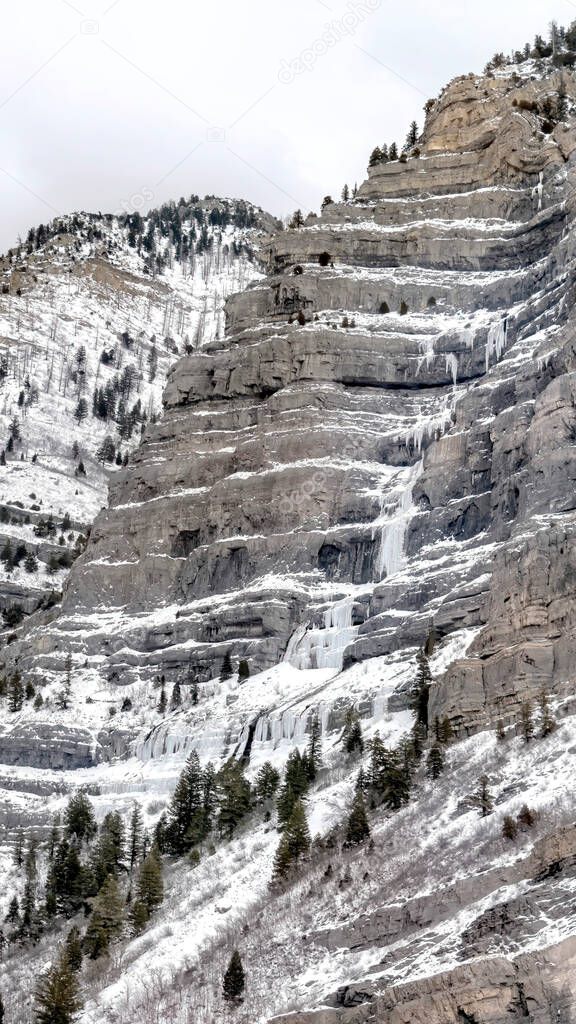 Vertical Crop Bridal Veil Falls In Provo Canyon With Water On Steep Slopes Frozen In Winter