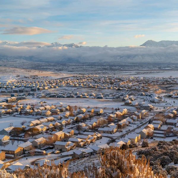 Coucher de soleil carré dans la vallée de l'Utah avec des maisons sur un quartier enneigé avec vue sur la montagne — Photo