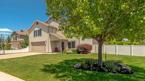 stock image Panorama frame Lush tree at the front yard of home with blue sky background on a sunny day