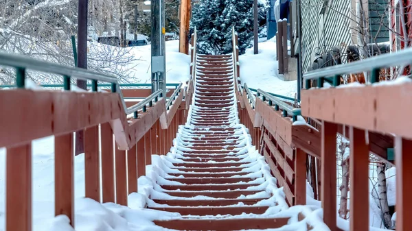 Panorama Treppe entlang farbenfroher Nachbarschaftshäuser auf malerischem, schneebedecktem Hügel im Winter — Stockfoto