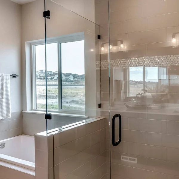 Square crop Frameless walk in shower stall and built in bathtub inside tile wall bathroom