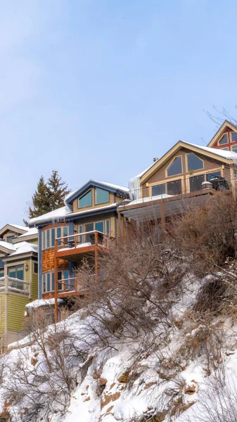 Vertical crop Homes with snowy roofs and balconies in scenic Park City Utah neighborhood