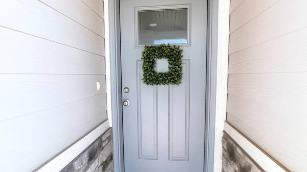 Panorama Square leafy wreath on front door entrance with glass pane and transom window