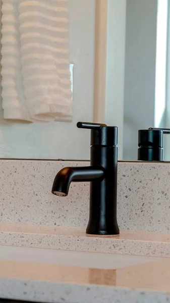 Vertical Black faucet and under mount sink against white countertop of home bathroom — Stock Photo, Image