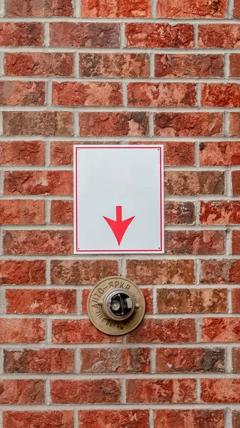 Vertical Brick wall with arrow pointing to fire sprinkler