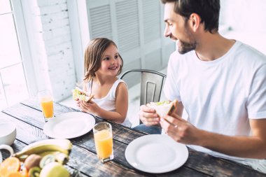 Seni seviyorum, baba! Yakışıklı genç adam evde küçük şirin kızı ile kahvaltı yaşıyorsanız. Mutlu babalar günü!
