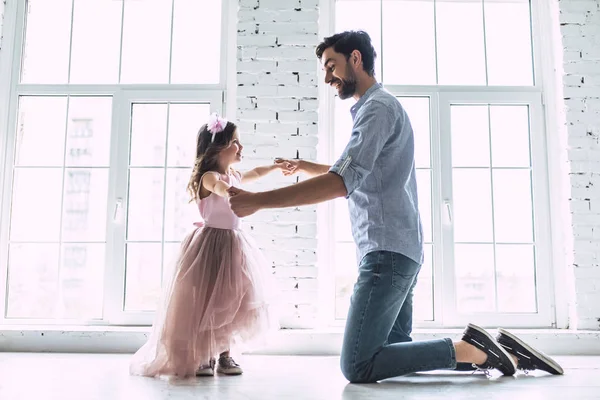 I love you, dad! Handsome young man is dancing at home with his little cute girl. Happy Father\'s Day!