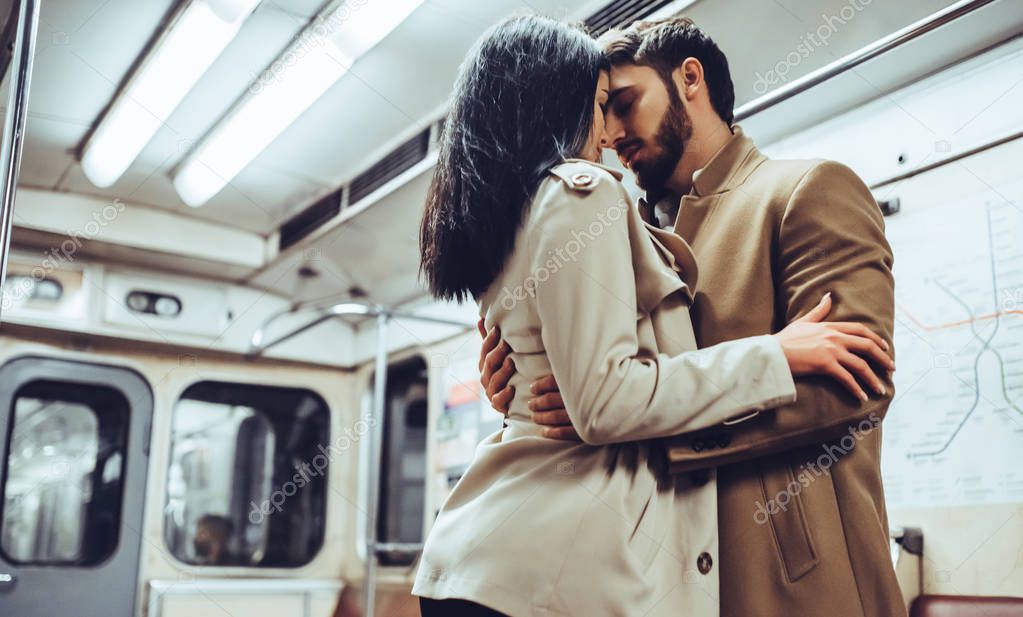 Young romantic couple in subway. Underground love story.
