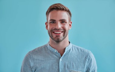 Yakışıklı adam izole. Mavi arka plan üzerinde poz şık genç adam.