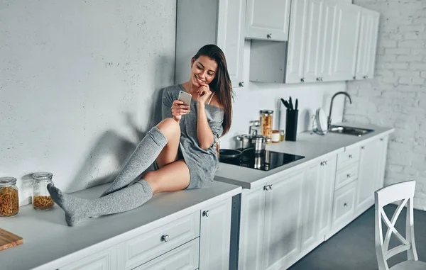 Good morning! Attractive young woman is having rest at home. Girl on kitchen.