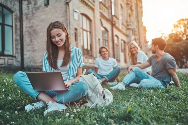 若い人たちのグループは 大学で勉強しています 一緒に芝生の上に座って屋外生 — ストック写真