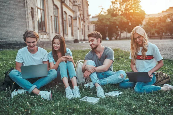 若い人たちのグループは 大学で勉強しています 一緒に芝生の上に座って屋外生 — ストック写真