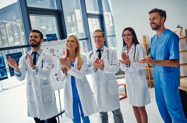 Group of doctors working together in clinic. Medical personnel in uniform.