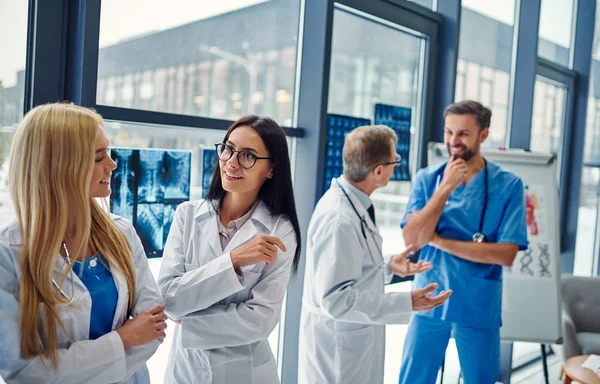 Group of doctors working together in clinic. Medical personnel in uniform.