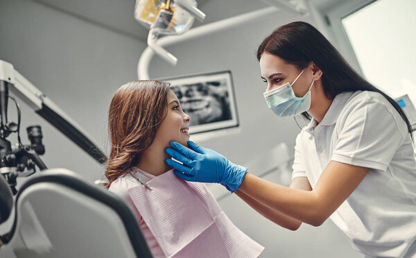 Cute girl in dental clinic. Child in stomatological cabinet with female dentist.