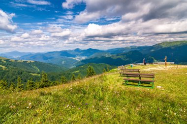 Manzara mavi gökyüzü bulutlu arka planda otsu çayır ve dağ zirveleri ile bahar. Donovaly alan Velka Fatra Milli Parkı, Slovakya, Avrupa.