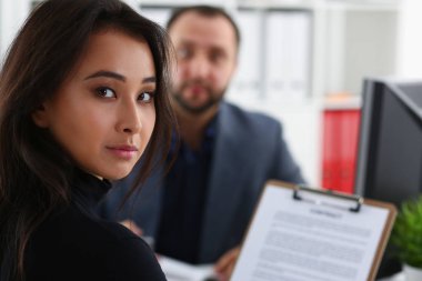 Genç güzel kadın sit Bakanlar Kurulu patronuyla ofiste masa sandalye üzerinde tutun Cilt kollarında