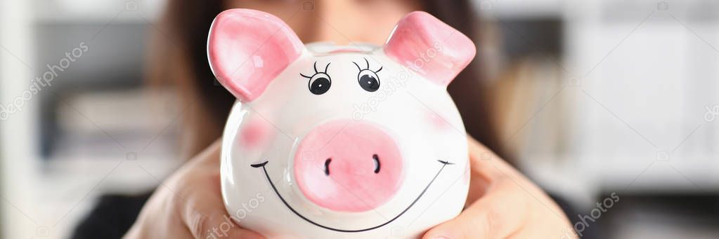 woman hold piggybank in arms