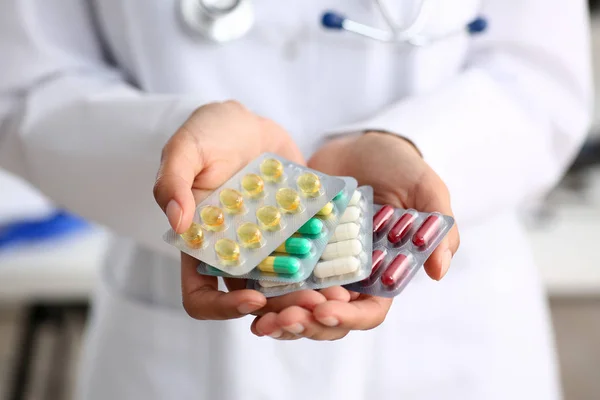 Female doctor hand holding pack of different — Stock Photo, Image