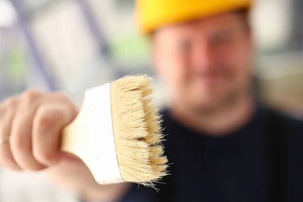 Arm of smiling worker hold brush closeup — Stock Photo, Image