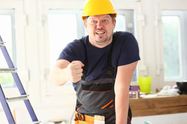 Sorrindo trabalhador engraçado no capacete amarelo posando — Fotografia de Stock