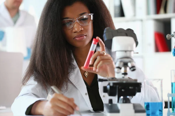 A male chemist holds test tube of glass — Stock Photo, Image