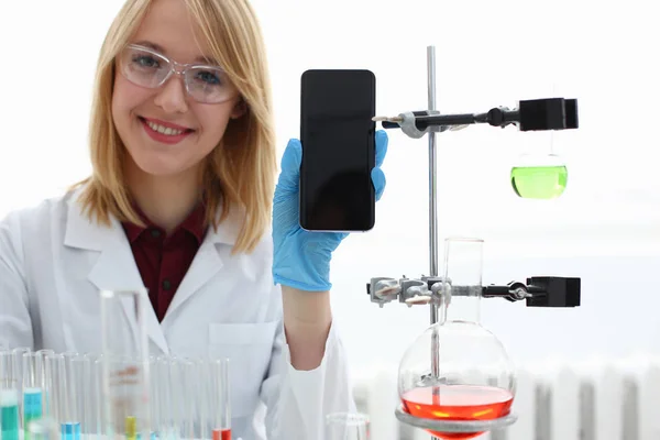 En kvinnlig läkare i ett kemiskt laboratorium innehar — Stockfoto