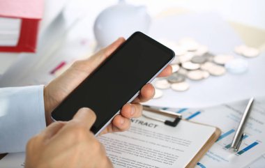 Yeni bir akıllı telefon mobil uygulama pazarı elinde imajın için reklam veya mali istatistikleri ekleyebileceğiniz bir görüntü gösterir bir işadamı tutar.