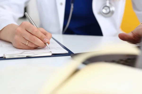 Lekarka ręka trzymać długopis srebrny napełniania pacjenta — Zdjęcie stockowe