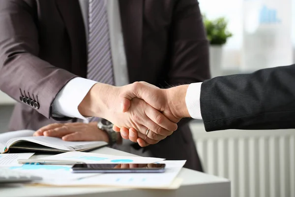 Man in suit shake hand as hello in office