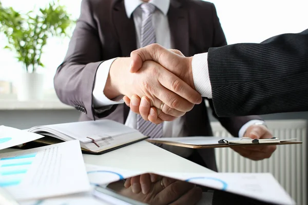 Man in suit shake hand as hello in office