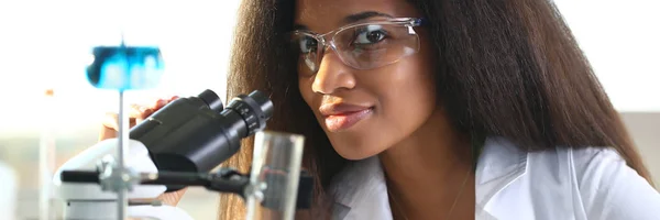 Black woman scientist student chemist in protective