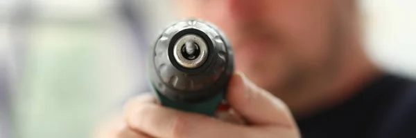 Arms of worker using electric drill closeup — Stock Photo, Image