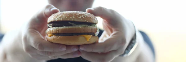 Tevreden jonge man met een hamburger — Stockfoto