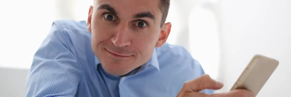 A businessman holds a new smartphone in his hand — Stock Photo, Image