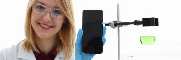 A female doctor in a chemical laboratory holds — Stock Photo, Image