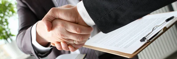 Man in suit shake hand as hello in office