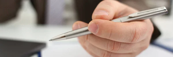 Male arm in suit and tie hold silver pen — Stock Photo, Image