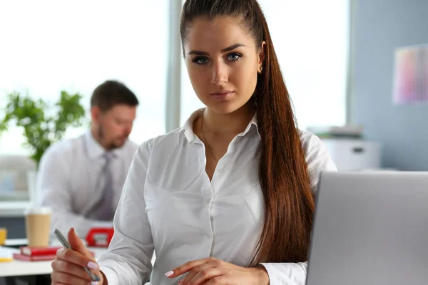 Mooi lachende meisje op werkplek in de camera kijken — Stockfoto