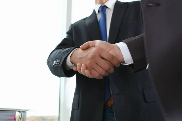 Man in suit shake hand as hello in office