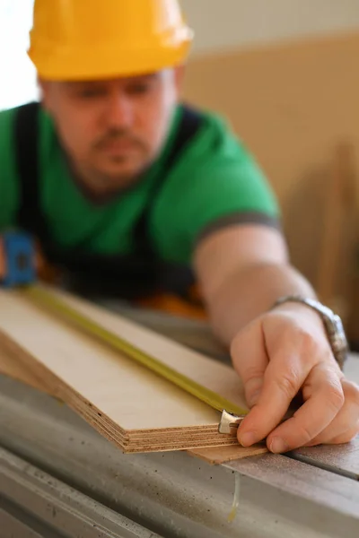 Handsome worker measuring. Manual — Stock Photo, Image