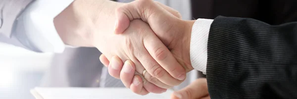 Man in suit shake hand as hello in office