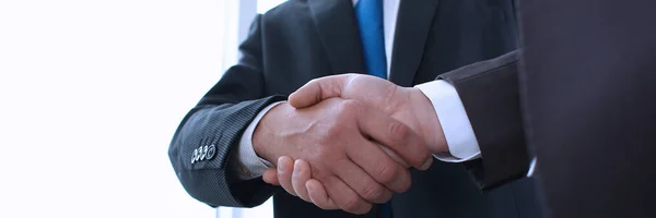 Man in suit shake hand as hello in office