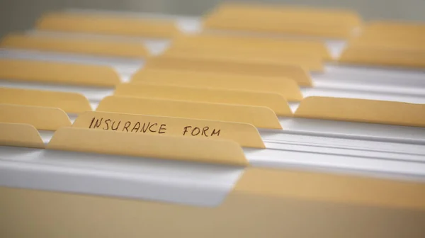 Yellow folders with labels and paper in a row — Stock Photo, Image