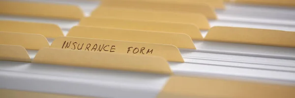Yellow folders with labels and paper in a row — Stock Photo, Image