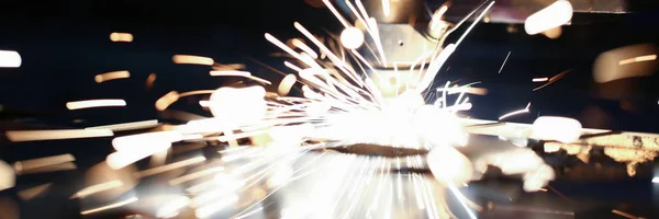 Sparks fly out machine head for metal processing