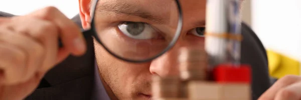 Businessman holds in hand black lens — Stock Photo, Image